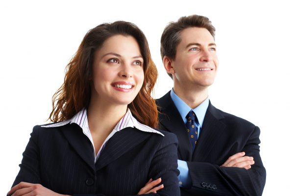 Two professionally dressed real estate agents smiling